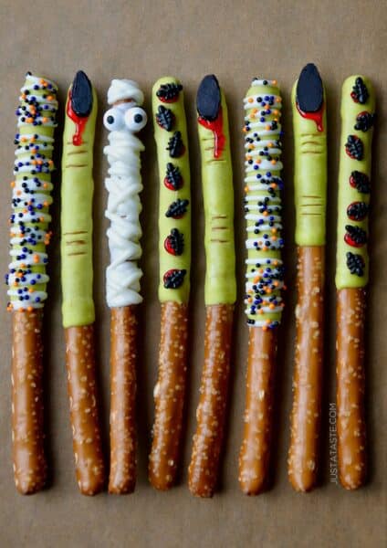 Spooky Halloween pretzel rods dipped in chocolate and decorated with festive sprinkles.